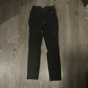 Good American light black/dark grey jeans with asymmetrical button closure.
